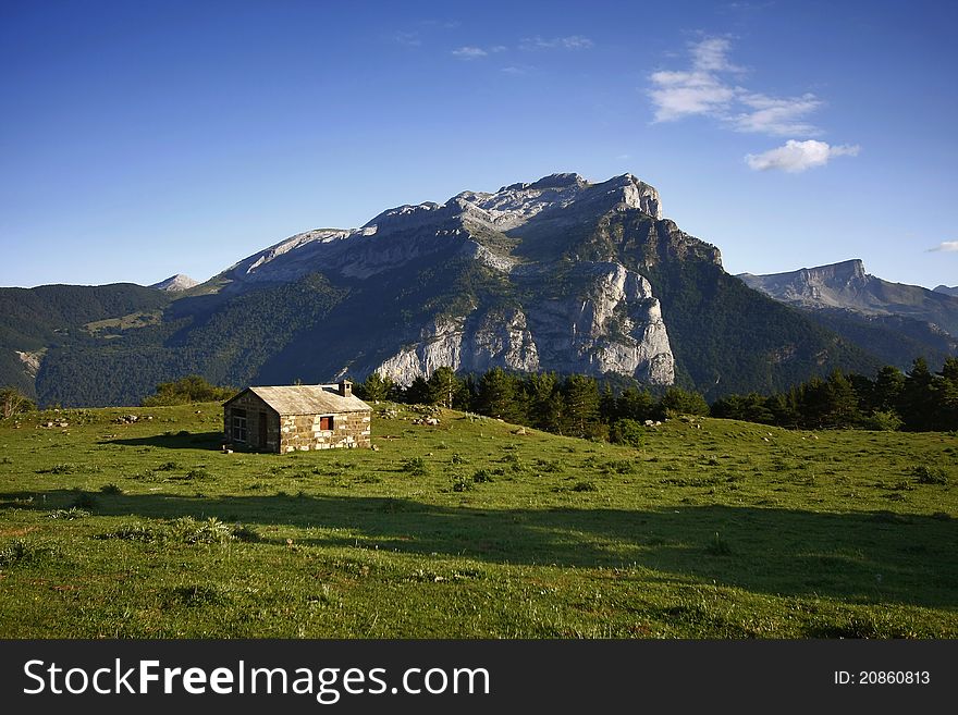 Little house in meadow of mountain