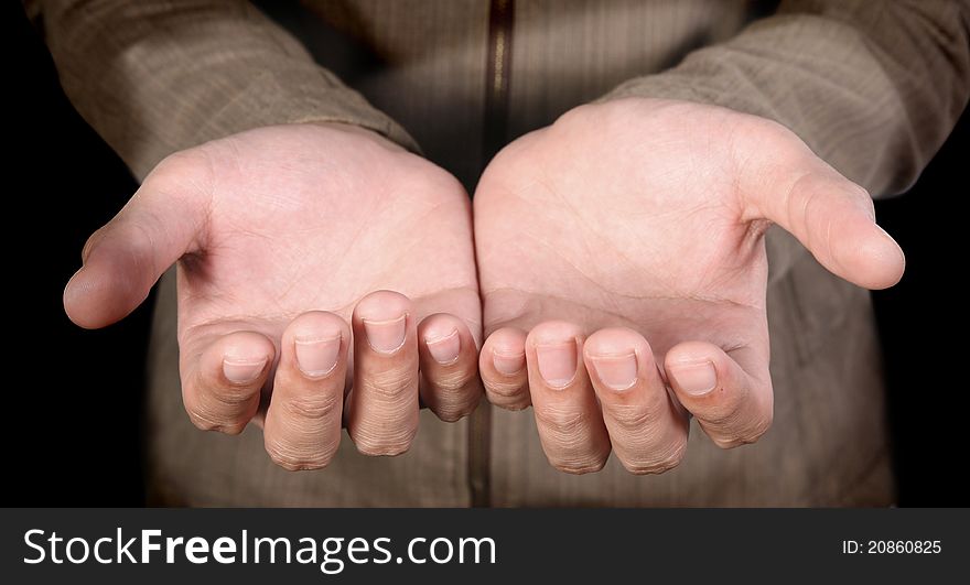Human hands on a dark background. Human hands on a dark background