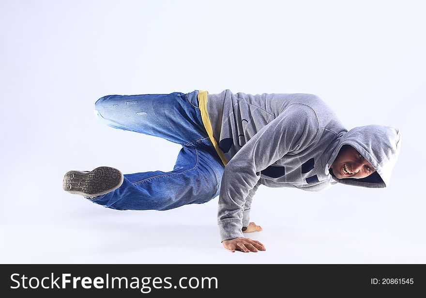 Young handsome fresh man breakdancing with stylish clothes.