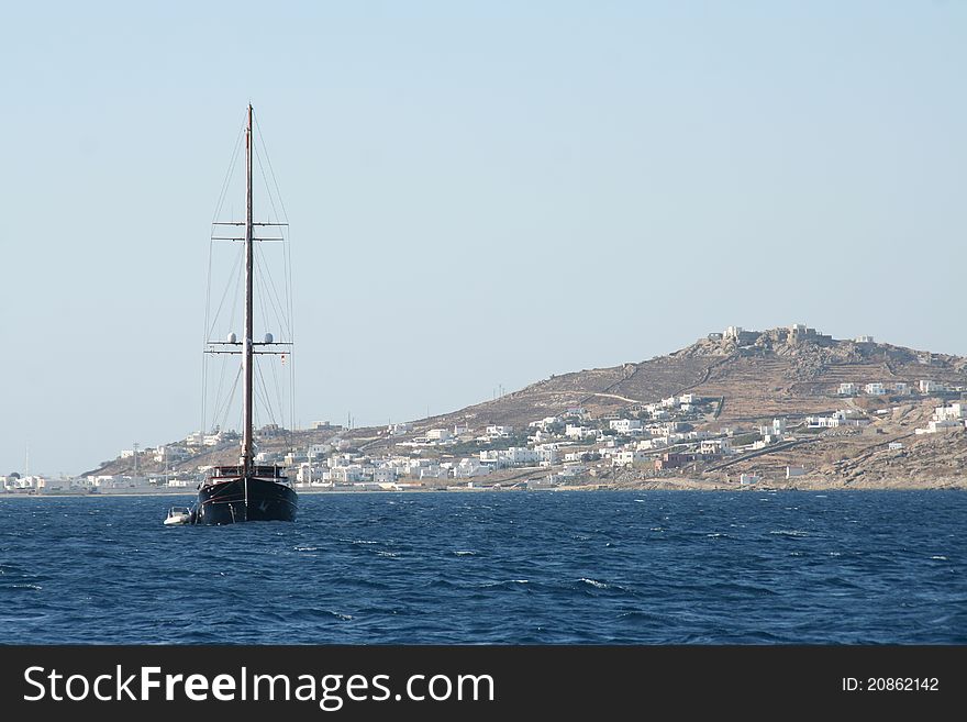 Sailing yacht anchoring in Mykonos, Greece. Sailing yacht anchoring in Mykonos, Greece.
