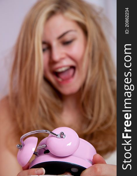 Young lady with alarm clock