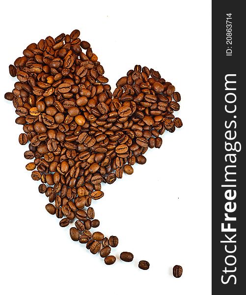 Roasted coffee beans in the shape of the heart.
