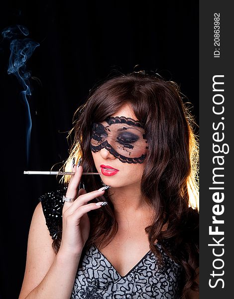 Smoking lady with lacy mask on black