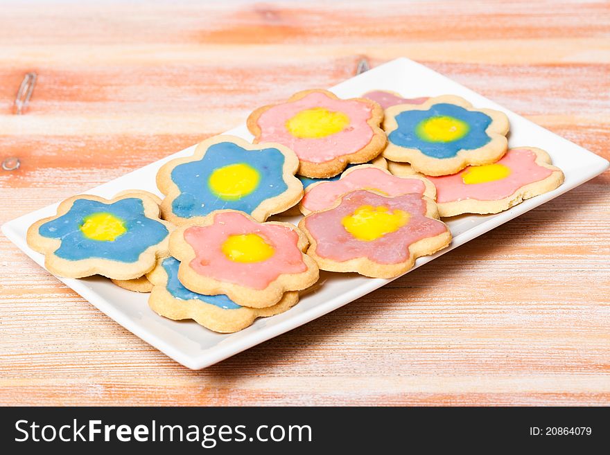 A plate of colourful homemade star shaped biscuits/cookies. Shallow depth of field. A plate of colourful homemade star shaped biscuits/cookies. Shallow depth of field.