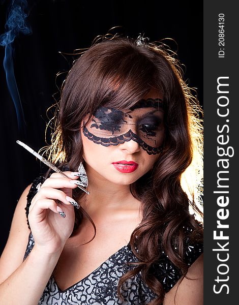 Smoking lady with lacy mask on black