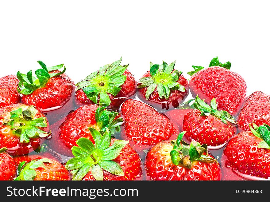 Group of red strawberries in water