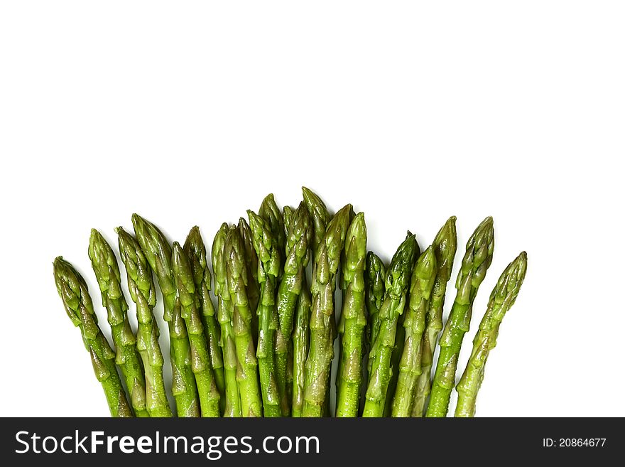 Fresh green asparagus tips on white background