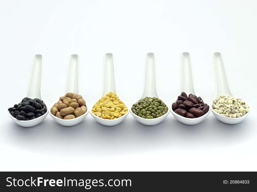 Cereal in spoon on a white background.