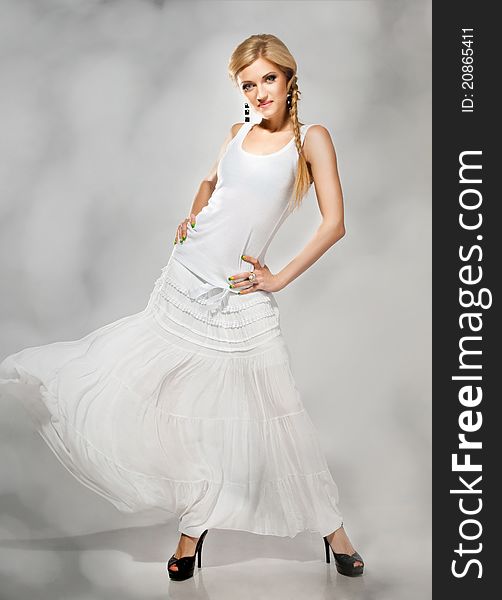 Beautiful fashion blonde in white dress billowing. Beautiful fashion blonde in white dress billowing
