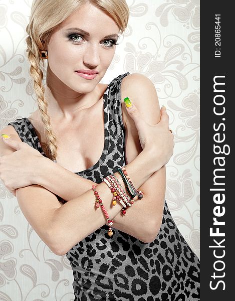 Beautiful blonde girl on a background wall with patterns