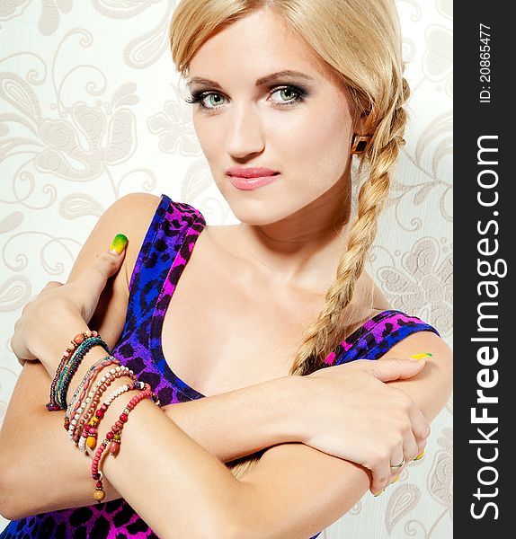 Beautiful blonde girl on a background wall with patterns