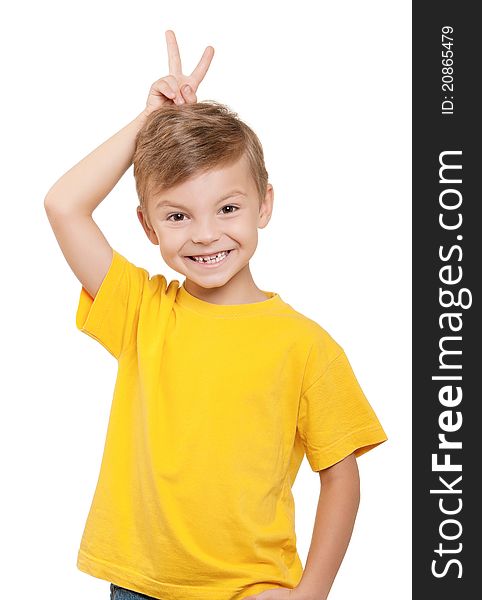 Portrait of little boy keeping two fingers above head over white background. Portrait of little boy keeping two fingers above head over white background