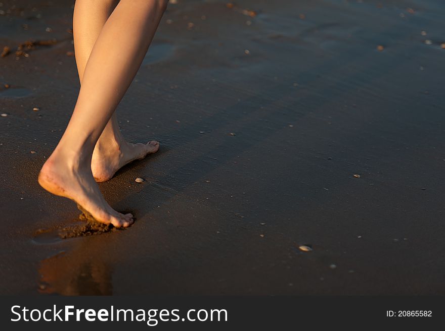 Woman is walking on the water beach. Woman is walking on the water beach