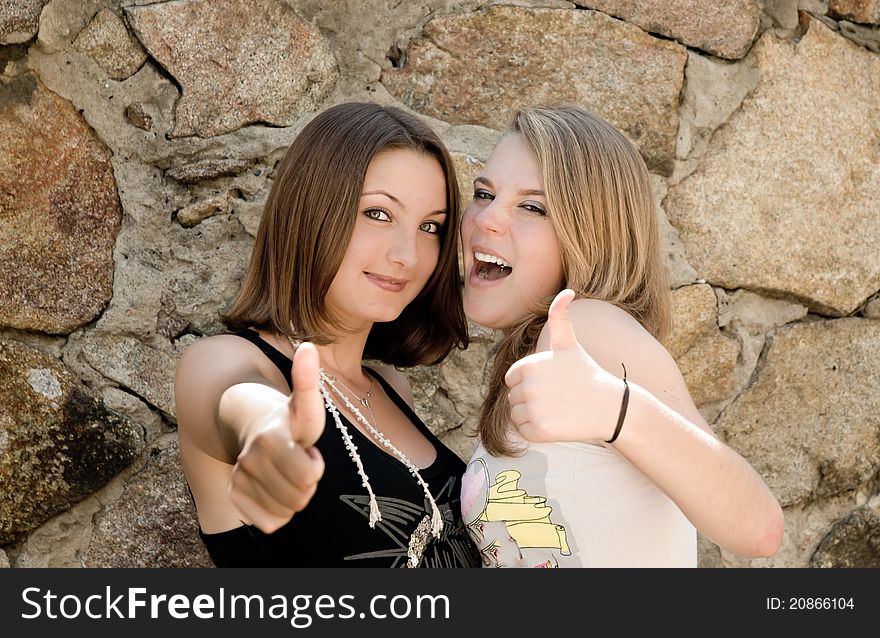 Two happy girls with thumbs up. Two happy girls with thumbs up