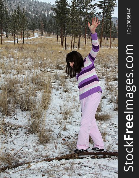 Young brunette teen playing in the field after the snowfall. Young brunette teen playing in the field after the snowfall