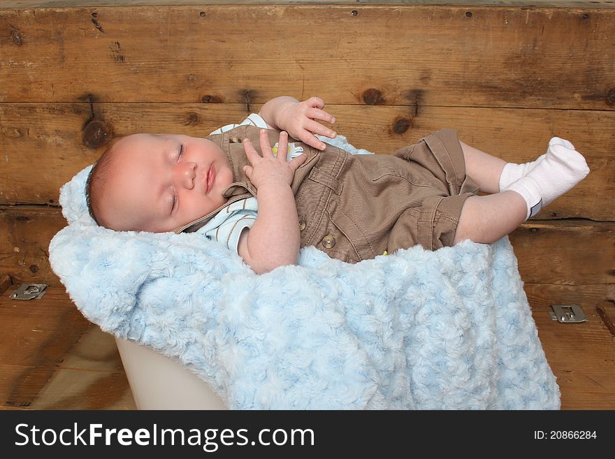 Beautiful newborn baby boy sleeping on a soft blanket. Beautiful newborn baby boy sleeping on a soft blanket