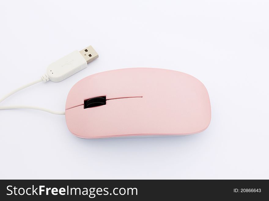 Pink optical mouse with white USB plug on a white background, focus on the mouse. Pink optical mouse with white USB plug on a white background, focus on the mouse