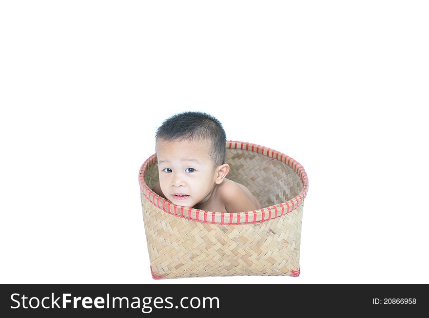 Boy sitting in rattan basket on isolated white background. Boy sitting in rattan basket on isolated white background