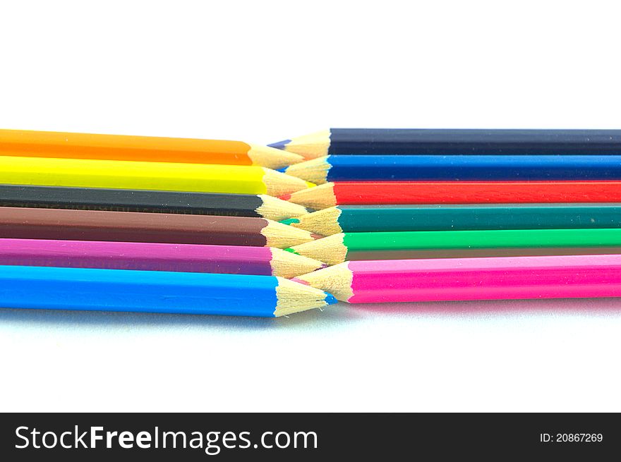 Many colored pencils over white