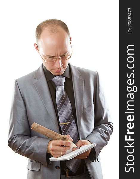 Man in a gray business suit, tie and glasses holding office supplies on an isolated white background. Man in a gray business suit, tie and glasses holding office supplies on an isolated white background