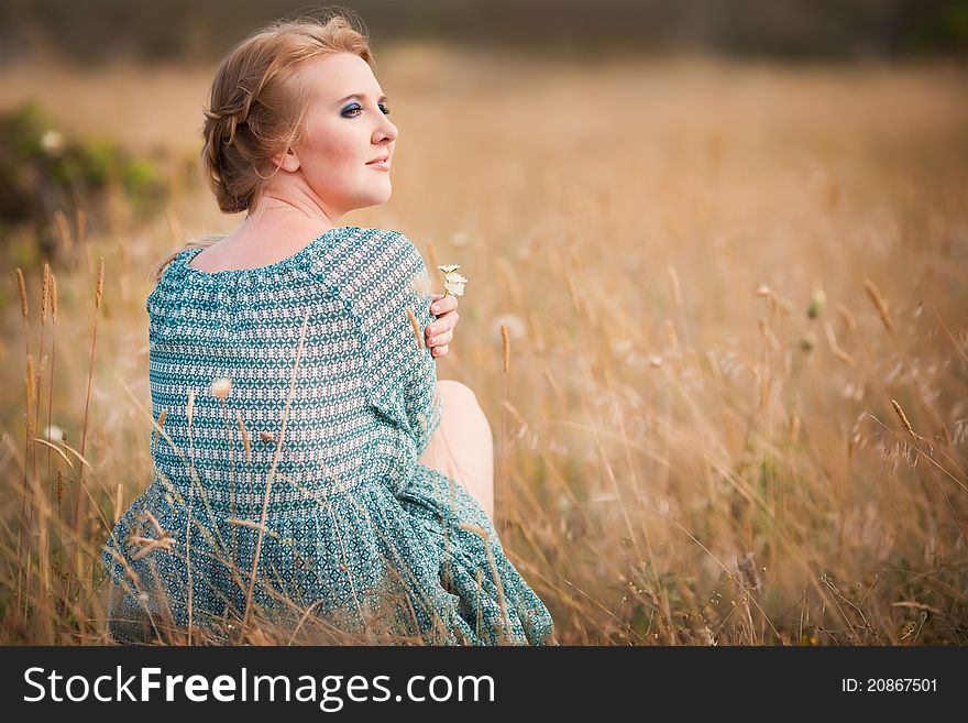 Beautiful woman relaxing in the straw in field. Beautiful woman relaxing in the straw in field