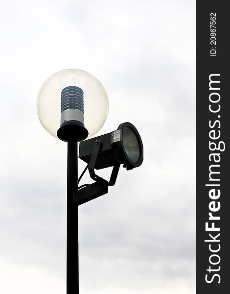 Street lamppost with one spotlight on the backdrop of cloudy sky. Street lamppost with one spotlight on the backdrop of cloudy sky.