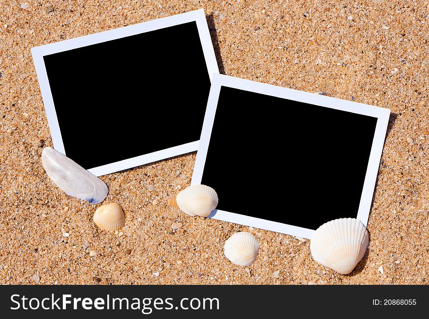 Sea shells with photos on sand background. Traveling to the sea concept. Sea shells with photos on sand background. Traveling to the sea concept.