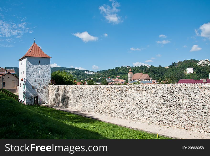 Wall and tower defence around the old town of Brasov in Romania. Medieval stone military structures. Wall and tower defence around the old town of Brasov in Romania. Medieval stone military structures