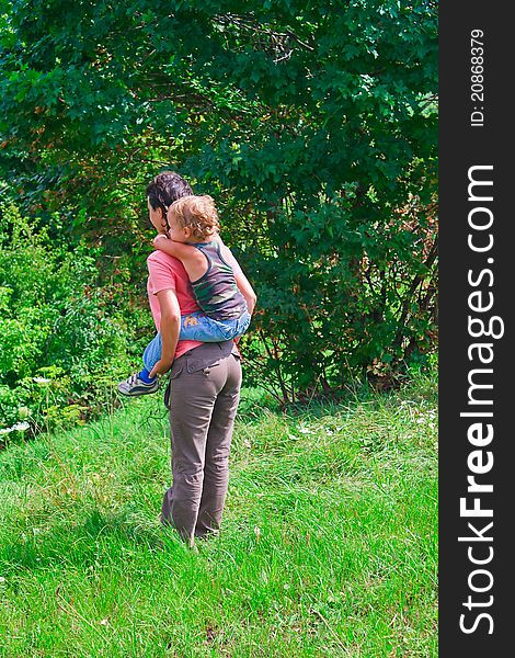 Mother and young son in a green forest. Mother and young son in a green forest