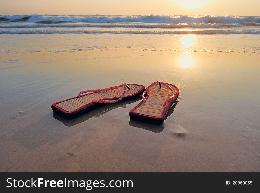 Beach sandals on the sandy beach at the sea. Beach sandals on the sandy beach at the sea