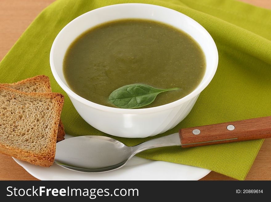 Spinach soup in a bowl with toast. Spinach soup in a bowl with toast