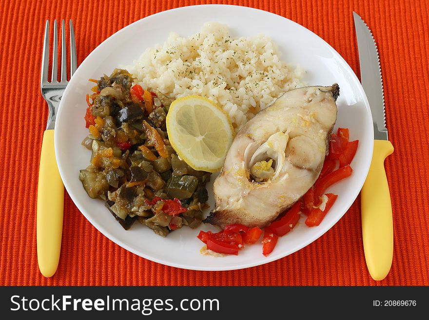 Boiled fish with rice, lemon and vegetables. Boiled fish with rice, lemon and vegetables