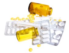 Pills And A Syringe On A White Royalty Free Stock Images