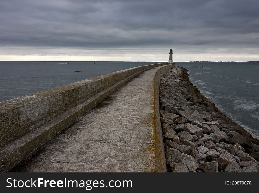 Lighthouse near the ocean. Moody weather before the storm.