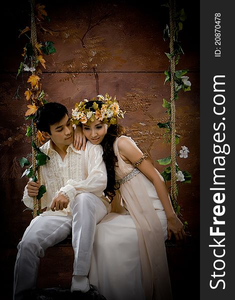 Portrait of young couple in antique dress in erotic emotion