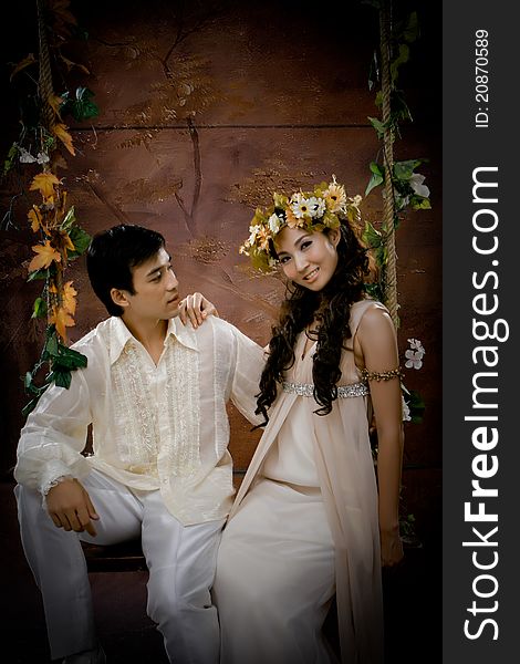 Portrait of young couple in antique dress in erotic emotion