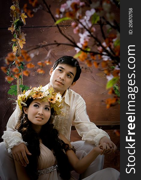 Portrait of young couple in antique dress in erotic emotion