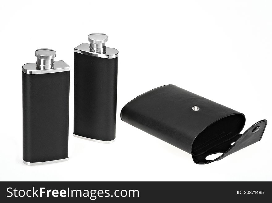 Portable set of flasks in leather case isolated on white