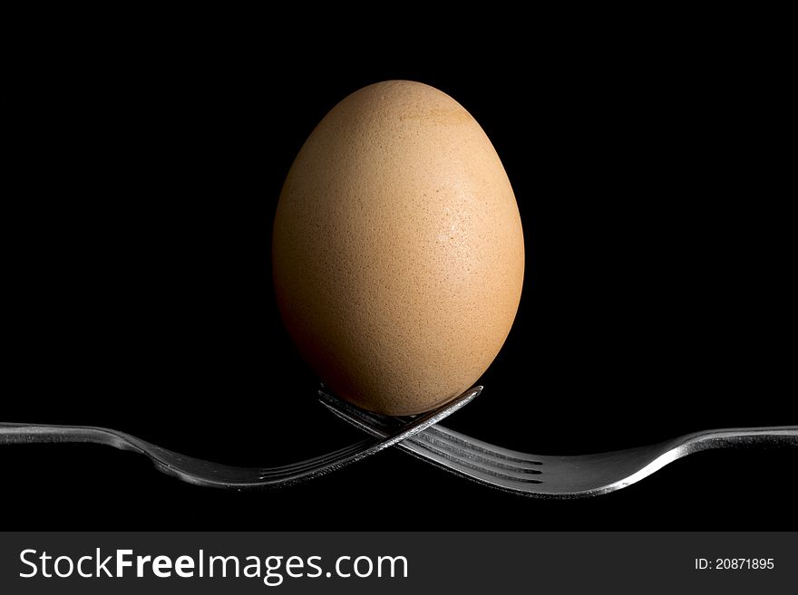 Egg on the bottom supported by two forks