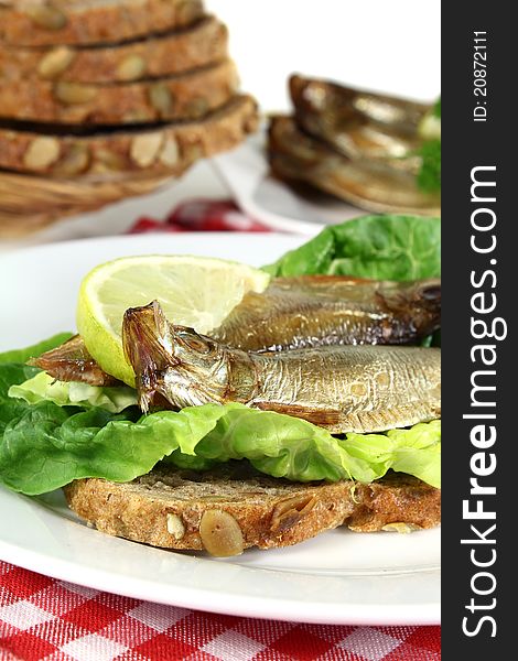 Smoked sprats on a slice of bread