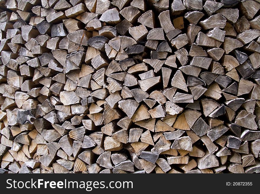 Background of pile of chopped firewood.