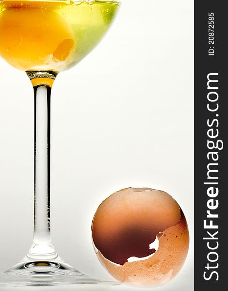 Egg in the glass and broken shell