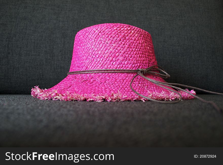 Pink beach hat, made of straw.