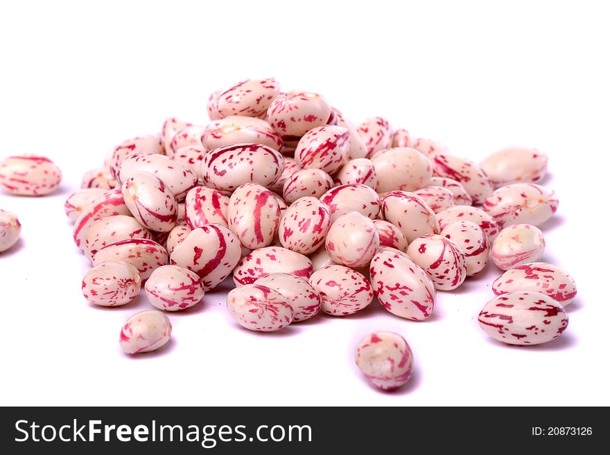 Close detail view of borlotti beans isolated on a white background.