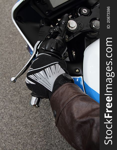 Top view of a biker's hand gripping the handlebar of his motorcycle. Top view of a biker's hand gripping the handlebar of his motorcycle