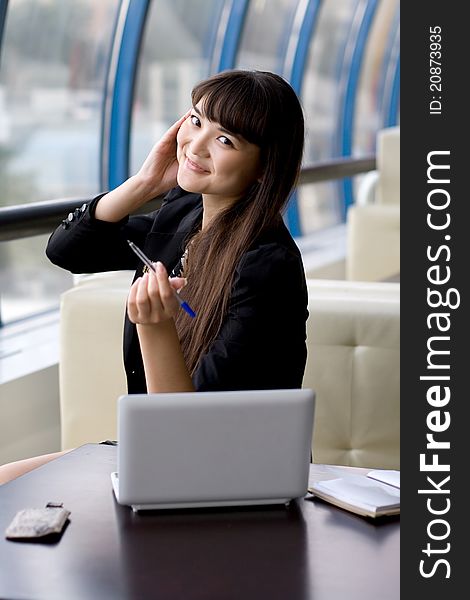 Cheerfull businesswoman with notebook and phone