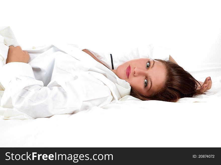 Beautiful girl lying on the snowy bed