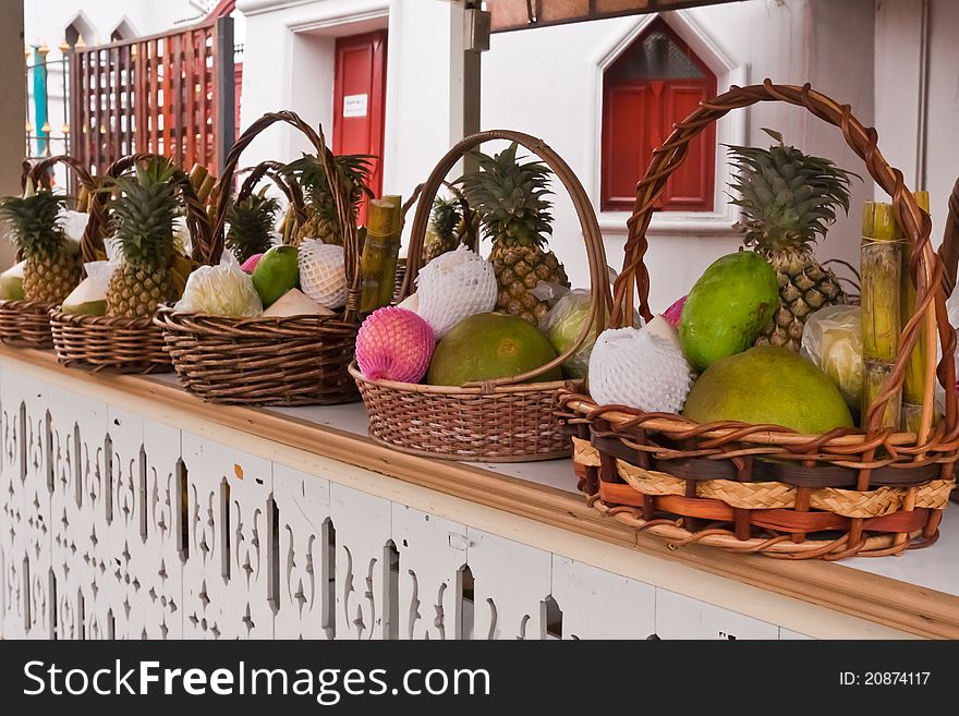 Fruits in basket on shelves included bananas sugarcanes coconuts and pineapples tilted left. Fruits in basket on shelves included bananas sugarcanes coconuts and pineapples tilted left