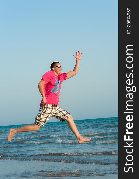 Young Man Jumping In The Ocean