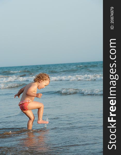 Child Is Walking In Ocean Water